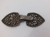 an image of a small metal bow tie on a white surface