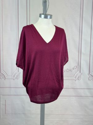 purple v - neck top on a mannequin base
