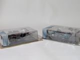two plastic boxes with cars in them on a white surface