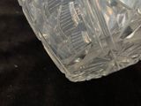 a clear glass vase on a black surface