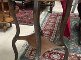 a table with a vase on top of it in a room