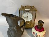 two vases and a clock sitting on a table