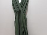 green dress hanging on a hanger next to a pair of underwear