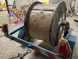 an image of a large reel on a trailer in a warehouse