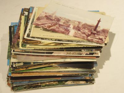 a stack of old postcards sitting on top of a table