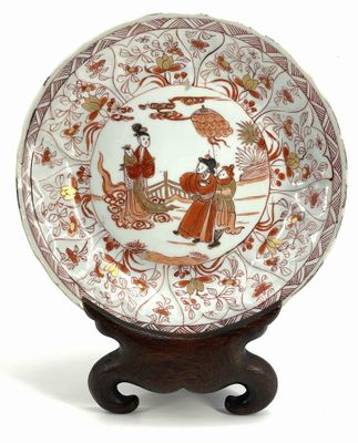 an image of a plate with a design on it on a wooden stand