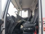 a white truck with a black seat and luggage in the back of it