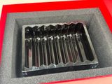 a picture of a red box with a bunch of knives in it
