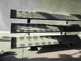 a black and white photo of a bench and a skateboard