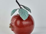 a red apple with a green leaf on top of it