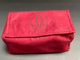 the red bag is sitting on the table with a monogrammed logo on it