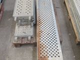 several pieces of metal are stacked on top of pallets in a warehouse