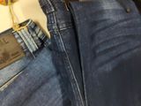 a pair of blue jeans and a pair of brown shoes