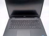 a dell laptop computer sitting on a white surface
