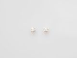 a pair of diamond stud earrings on a white background