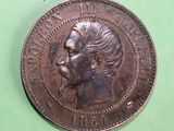 an old coin with a man ' s face on it on a green surface