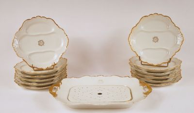 several plates and bowls with gold trims are stacked on top of each other