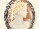 a close up of a picture of a woman ' s face in a pendant