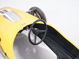 a close up of a yellow race car with a steering