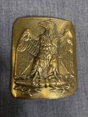 an image of a gold belt buckle with an eagle on it
