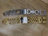 two gold and silver bracelets on a wooden surface