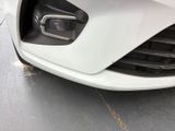 a close up of a white car ' s front bumper