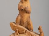 sculpture of a bear and a squirrel sitting on a log