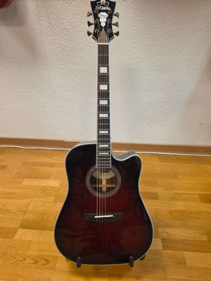 an acoustic guitar sitting on top of a wooden floor next to a wall