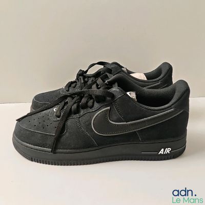 black nike air force low sneakers on a white surface