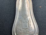 a silver spoon with a picture of a castle on it