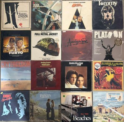 many different album covers on the wall of a room