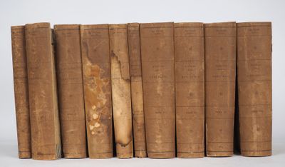 several old books are lined up in a row on a white surface