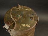 a small metal container with a handle on a black background