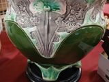 a green and white bowl sitting on a red table