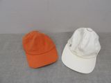 two hats that are sitting next to each other on a table