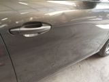 a close up of a car door handle with a sticker on it