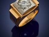 a yellow gold ring with a diamond set in the center
