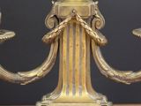 two candles that are sitting on a wooden table