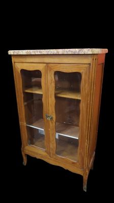 a wooden cabinet with glass doors and a marble top
