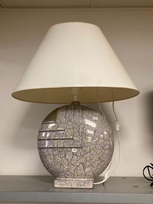 a lamp that is sitting on a shelf next to a television