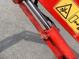 a red excavator that has a sign on it