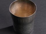 a close up of a cup of coffee on a black surface