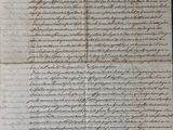 an old document with writing on it sitting on top of a table