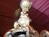 a statue of a woman sitting on top of a clock