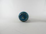a close up of a small blue object on a white surface