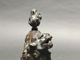 chinese bronze figurine of a seated dog with a bird on its back