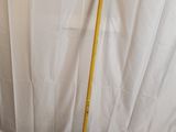 a broom that is sitting on top of a sheet of paper