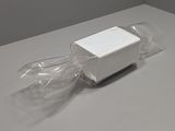 a white box that is wrapped in plastic on a table