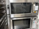 two microwaves that are sitting on top of a counter