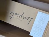 a cardboard box with a sign on it sitting on the floor